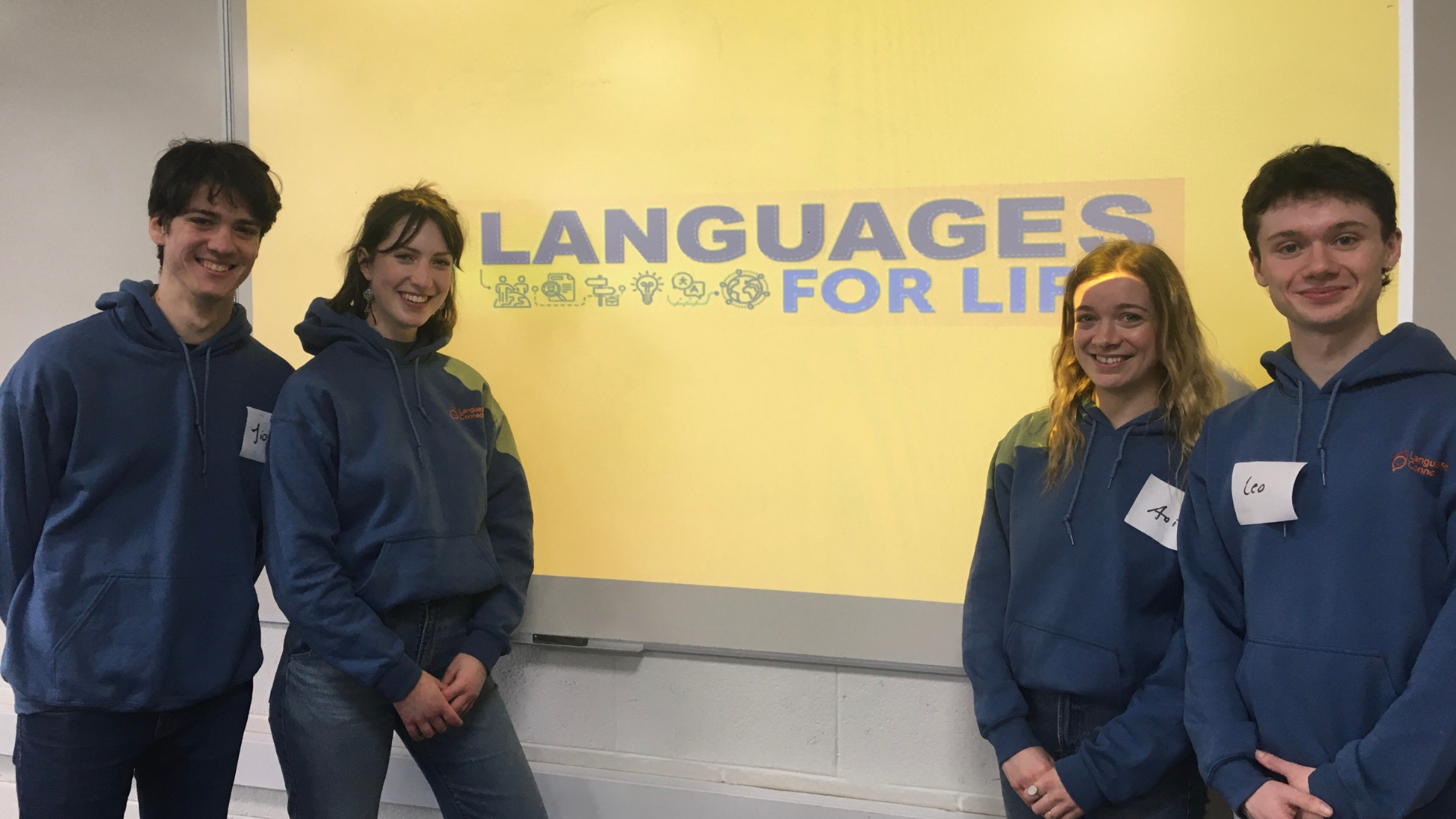 4 student ambassadors in front of a whiteboard